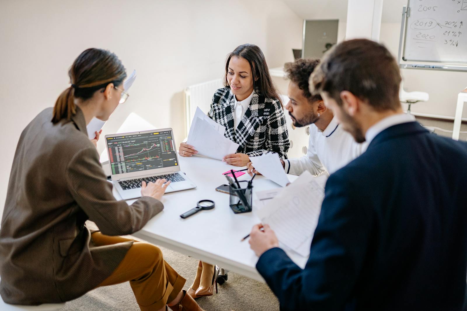 Team of professionals reviewing a laptop during a business meeting.